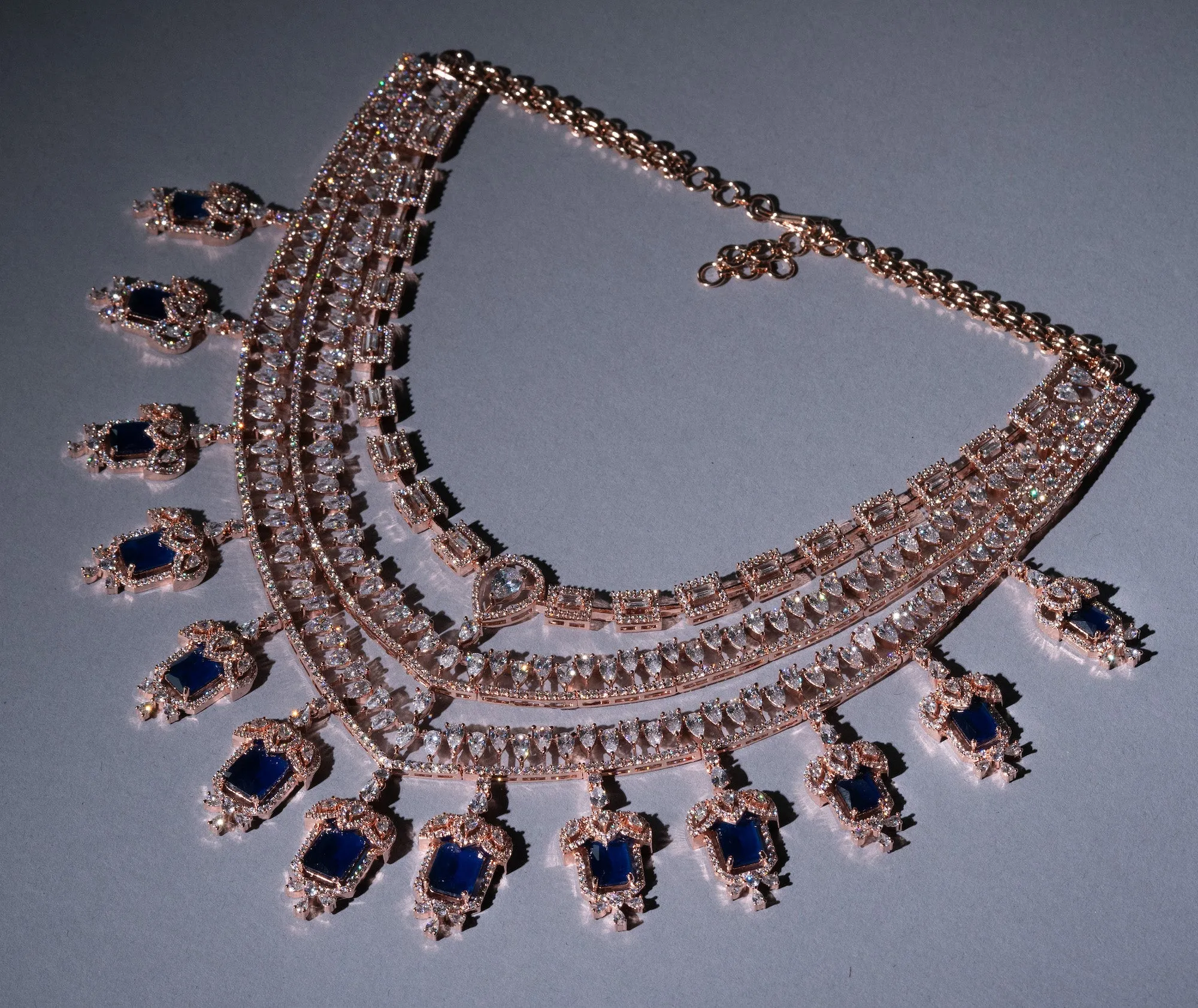 Grace Sapphire Blue Chandelier Statement Necklace Set Designer Rose Gold Plated Fashion Jewelry by Jaipur Rose Indian Jewelry Online