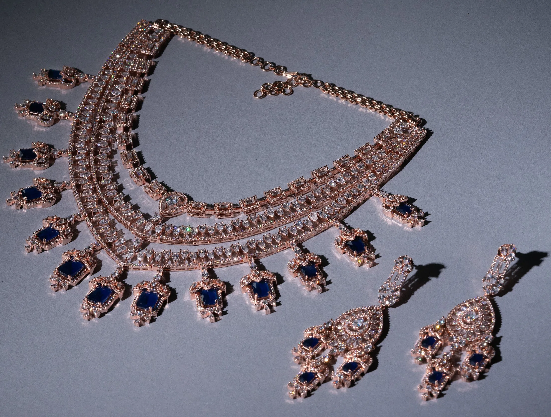 Grace Sapphire Blue Chandelier Statement Necklace Set Designer Rose Gold Plated Fashion Jewelry by Jaipur Rose Indian Jewelry Online